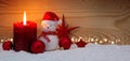 Advent candle and Snowman with Christmas decorations . Royalty Free Stock Photo