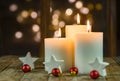 Advent candles with christmas decoration and sparkling lights background Royalty Free Stock Photo