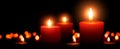 Advent candles, three flames in the foreground Royalty Free Stock Photo