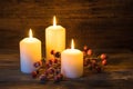 Christmas background with burning candles and red berries decoration. Royalty Free Stock Photo