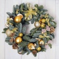 Advent Christmas wreath with gold decorations, handmade on a wooden background. Year`s interior decoration Royalty Free Stock Photo