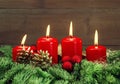 Advent decoration with four red burning candles Royalty Free Stock Photo