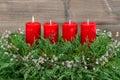 Advent decoration wreath with four red burning candles Royalty Free Stock Photo