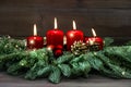 Advent decoration wreath with four red burning candles and light Royalty Free Stock Photo