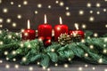 Advent decoration wreath four red burning candles lights