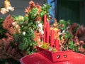 Advent postcard. Four red burning candles in a beautiful candlestick. Decorated Christmas tree background. First candle in focus. Royalty Free Stock Photo