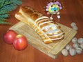 Advent still life with Christmas knit bread, apples and nuts. Apple decorated candies. On a wooden board table. Branch of conifer