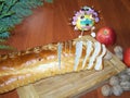 Advent still life with Christmas knit bread, apples and nuts. Apple decorated candies. On a wooden board table. Branch of conifer