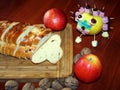 Advent still life with Christmas knit bread, apples and nuts. Apple decorated candies. On a wooden board table