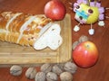 Advent still life with Christmas knit bread, apples and nuts. Apple decorated candies. On a wooden board table