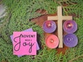 Advent week 3 joy text written on paper with cross, candles and wreath background. Christmas preparation or Advent season concept. Royalty Free Stock Photo