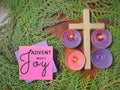 Advent week 3 joy text written on paper with cross, candles and wreath background. Christmas preparation. Advent season concept. Royalty Free Stock Photo