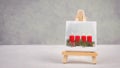 Advent wreath, christmas decoration with red candle light, drawing on an easel, copy space for text, holiday greeting card Royalty Free Stock Photo