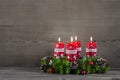 Advent wreath or crown with four red candles on wooden background. Royalty Free Stock Photo