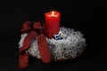 Advent wreath with one burning candle and red loop Royalty Free Stock Photo