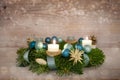 Advent wreath series number two with lit candles, blue Christmas baubles and decoration on a rustic wooden snowy background, Royalty Free Stock Photo