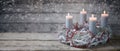 Advent wreath of white painted branches with burning candles and a red chain decoration, tradition in the time before Christmas, Royalty Free Stock Photo