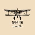 Adventure awaits motivational quote. Vintage retro airplane logo.Hand sketched aviation illustration in engraving style. Royalty Free Stock Photo