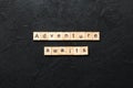 Adventure awaits word written on wood block. Adventure awaits text on cement table for your desing, concept Royalty Free Stock Photo