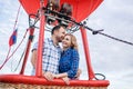 Adventure. Beautiful romantic couple hugging in bascket hot air balloon