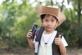 An adventure boy is using a binocular