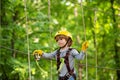 Adventure climbing high wire park. Cute school child boy enjoying a sunny day in a climbing adventure activity park Royalty Free Stock Photo