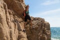 Adventure girl climbs on a cliff, rich the target Royalty Free Stock Photo