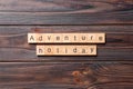 Adventure holiday word written on wood block. adventure holiday text on cement table for your desing, concept Royalty Free Stock Photo