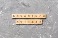 Adventure holiday word written on wood block. adventure holiday text on cement table for your desing, concept Royalty Free Stock Photo