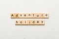 adventure holiday word written on wood block. adventure holiday text on cement table for your desing, concept Royalty Free Stock Photo