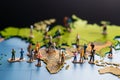 Adventure journey Miniature people exploring a world map, travel concept