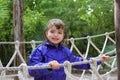 Adventure little girl on jungle park rope bridge Royalty Free Stock Photo