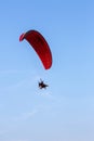 Adventure man active extreme sport pilot flying in sky with paramotor engine glider parachute. Royalty Free Stock Photo