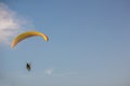 Adventure man active extreme sport pilot flying in sky with paramotor engine glider parachute. Royalty Free Stock Photo