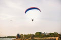 Adventure man active extreme sport pilot flying in sky with paramotor engine glider parachute. Royalty Free Stock Photo