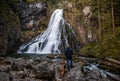 Adventure Man with Dog Hiking at Gollinger Waterfall in Austria