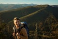 Adventure man enjoying nature and looking happy on top of mountain, hiking expedition