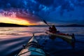 Adventure Man on a Sea Kayak is kayaking during Sunset Royalty Free Stock Photo