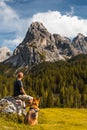 Adventure Man Sitting on Rock at Hiking Trial with Best Freind Dog