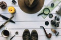 Adventure planning flat lay. Travel vintage gear on white wooden table. Including film camera, hat, knife, magnifier, compass. Royalty Free Stock Photo