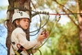 adventure rope park. Girl climbing on tree