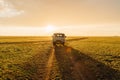 Old post soviet off-road vehicle car UAZ bus rides on a country road. Royalty Free Stock Photo