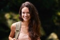 Adventure time. Portrait of a young woman standing in the forest.