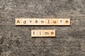 Adventure time word written on wood block. Adventure time text on cement table for your desing, concept Royalty Free Stock Photo