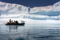 Adventure tourists near a large iceberg - Antarctica