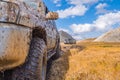 Adventure travel concept background. 4x4 off-road suv car stuck in mud. Royalty Free Stock Photo