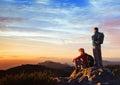 Adventure travel, couple of hikers relaxing on top of mountain, active tourism