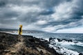 Adventure travel man lifestyle standing people on the cliff coast with storm in background - nature outdoor wild lifestyle and Royalty Free Stock Photo