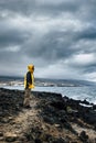 Adventure travel man lifestyle standing people on the cliff coast with storm in background - nature outdoor wild lifestyle and Royalty Free Stock Photo