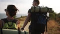 Adventure, travel, tourism, hike and people concept. Rare footage of a couple hiling the hills together with backpacks